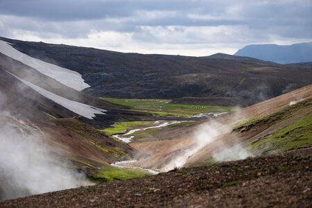 Volcanic active landscape with frog, glacier, hills and green moss on the Fimmvorduhals trail near Landmannalaugar of summer sunny day, Icelandの写真素材