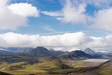 View mountain valley with green hills, river stream and lake. Laugavegur hiking trail, Iceland.