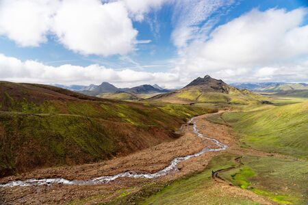 View mountain valley with green hills, river stream and lake. Laugavegur hiking trail, Iceland.