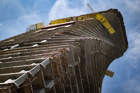Very tall building under construction with sky background.