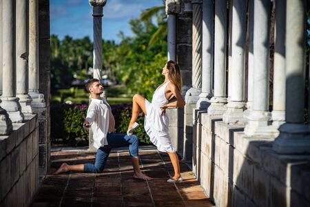 Young happy couple dancing in the summer parkの写真素材