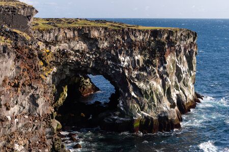 Sea scape with dangerous vertical cliff, cloudscape during sunsetの写真素材