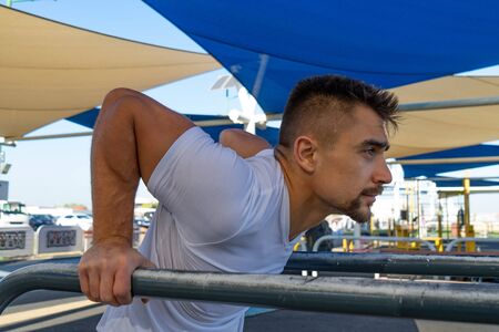 Muscular man doing workout on the street in Dubai. Concept of healthy lifestyleの写真素材
