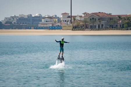 Water extreme sport. The guy is flying at the aquatic flyboard. Extreme rest on the seaの写真素材