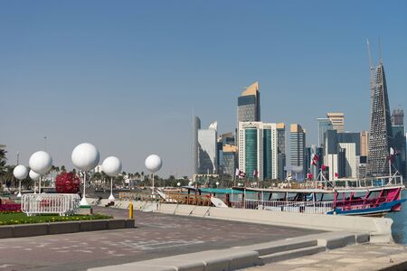 Skyscrapers in the city center with water and boat foreground of Doha, Qatar 2020.の写真素材
