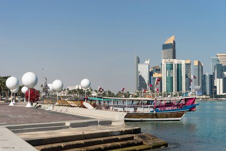 Skyscrapers in the city center with water and boat foreground of Doha, Qatar 2020の写真素材