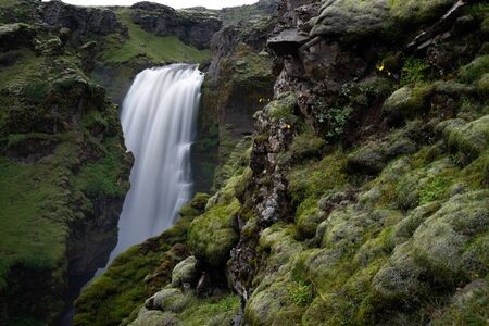 Beautiful smooth waterfall in Iceland during evening dusk.の写真素材