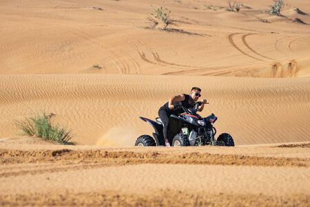 Muscular Man Riding Atv In the Desert. の写真素材