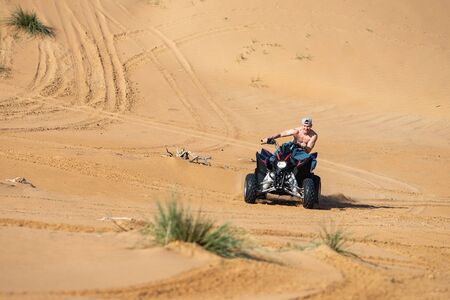 Muscular Man topless Riding Atv In the Desert.の写真素材