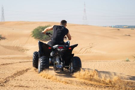 Muscular Man Riding Atv In the Desert. の写真素材