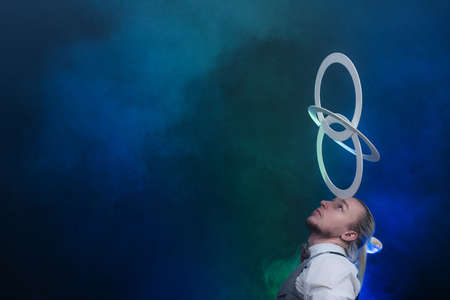 Man wearing formal suit juggling with white rings. Management, control and successの写真素材