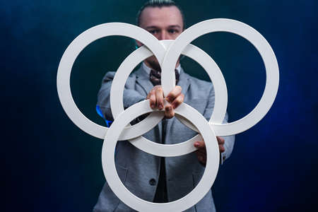 Man wearing formal suit juggling with white rings. Management, control and successの写真素材