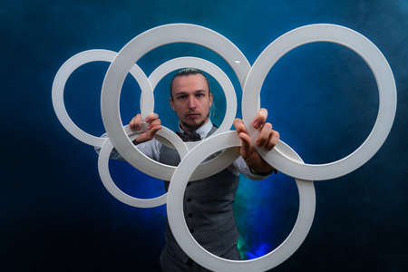 Man wearing formal suit juggling with white rings. Management, control and successの写真素材