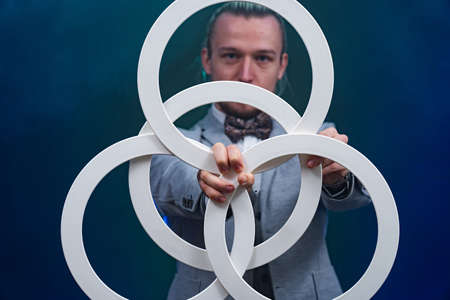 Man wearing formal suit juggling with white rings. Management, control and successの写真素材