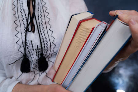 Closeup of Hands Holding A Stack Of Books. Concept of self-education, self-developmentの写真素材