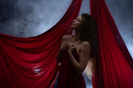 Gorgeous nude woman with red color silk. Concept of Sexuality and sensitivityの写真素材