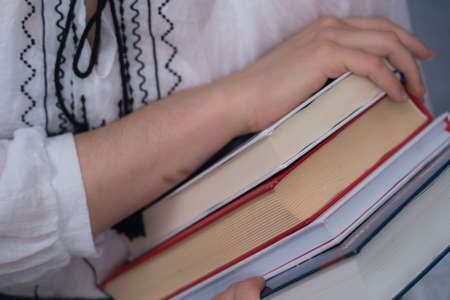 Closeup of Hands Holding A Stack Of Books. Concept of self-education, self-developmentの写真素材