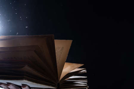 Vintage open Book Glows In The Darkness. Concept of wisdom and knowledgeの写真素材