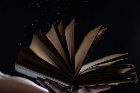 Vintage open Book Glows In The Darkness. Concept of wisdom and knowledgeの写真素材