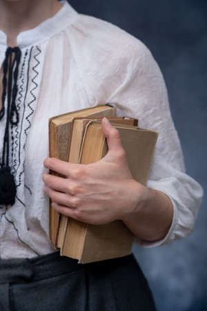 Closeup of Hands Holding A Stack Of Books. Concept of self-education, self-developmentの写真素材
