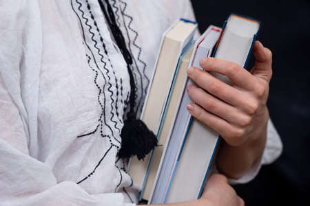 Closeup of Hands Holding A Stack Of Books. Concept of self-development during self-isolationの写真素材