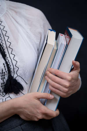 Closeup of Hands Holding A Stack Of Books. Concept of self-development during self-isolationの写真素材
