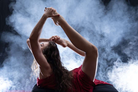 Nude sexual woman doing yoga. Dark romantic light. Health and sexualityの写真素材