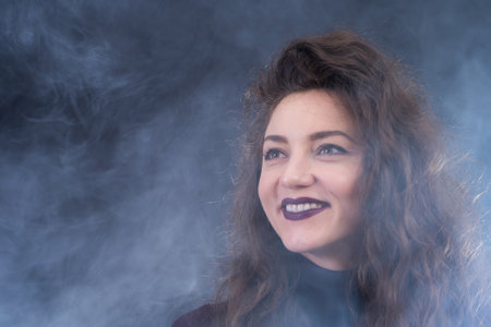 Happy, curly, smiling, Self-Assured Woman On Isolated Background.の写真素材