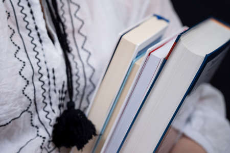 Closeup of Hands Holding A Stack Of Books. Concept of self-education, self-developmentの写真素材