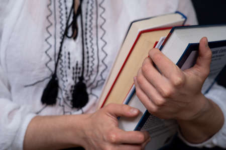 Closeup of Hands Holding A Stack Of Books. Concept of education and studentsの写真素材