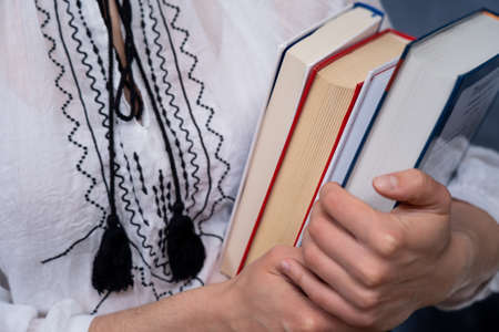 Closeup of Hands Holding A Stack Of Books. Concept of self-development during self-isolationの写真素材