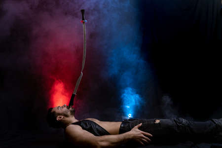 Circus artist hold knife in the mouth and keep in balance sword on itの写真素材
