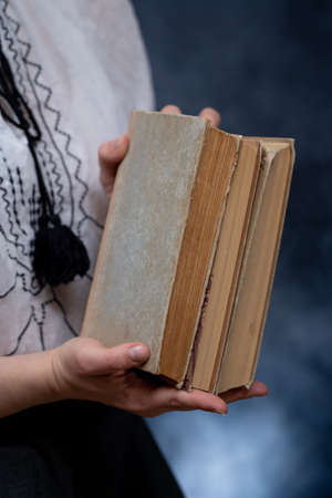 Closeup of Hands Holding A Stack Of Books. Concept of self-development during self-isolationの写真素材