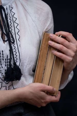 Closeup of Hands Holding A Stack Of vintage old Books. Concept of self-education, self-developmentの写真素材