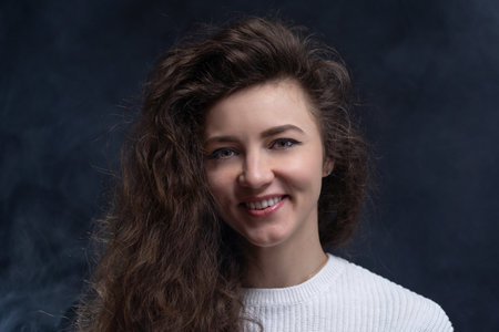 Happy, curly, smiling, Self-Assured Woman On Isolated Background.の写真素材