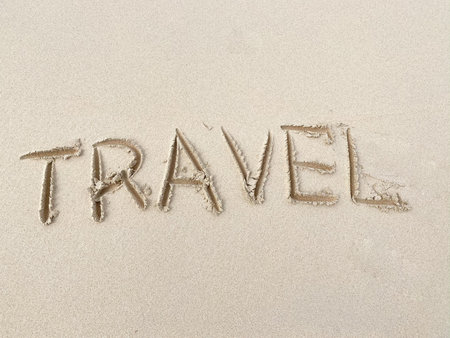 Travel inscription on summer sandy beach. Vacation and adventure conceptの写真素材
