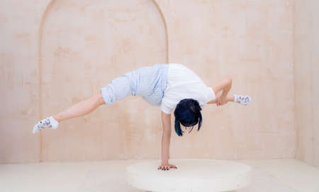 Flexible girl practice stretching and handstand at home. concept of quarantine time during self...