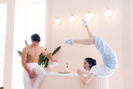 man and woman drinking and doing romantic party for two at home.Date, relationship, chill concept.の写真素材