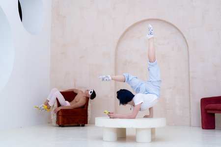 Couple in pajamas resting at home by creative way. Concept of boredom during COVID self isolationの写真素材