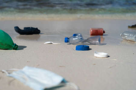 White sand Beach With Plastic garbage. Concept of pollution and environmental impactの写真素材