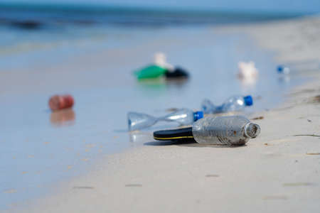 White sand Beach With Plastic garbage. Concept of pollution and environmental impactの写真素材