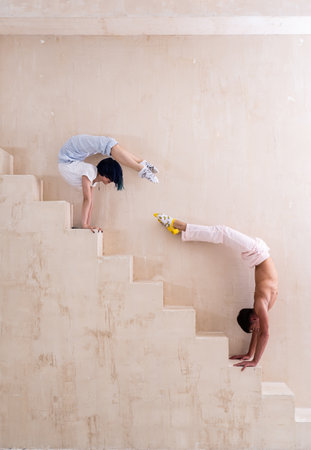Flexible woman and man doing stretching and handstand in studio. Concept of willpower, motivation and healthy lifestyleの写真素材