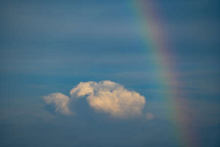 Rainbow over cloudy sky and seaの写真素材