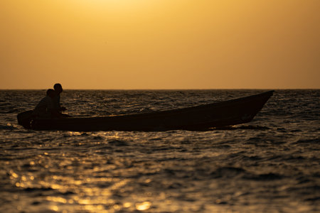 Traditional wooden boat with motor of the fisherman on sunset background. Travel and explore concept.の写真素材