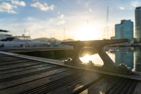 Closeup of empty metal cleat on a yacht deck during sunsetの写真素材