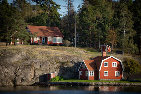 Old traditional red fisherman summer house in Sweden. scandinavian backgroundの写真素材