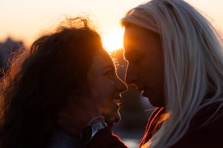 Silhouette of young romance between man and woman on sunset close up. Concept of feelings and attractionの写真素材