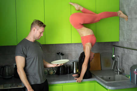 Hungry husband on the kitchen ask wife for food. Concept of family, relationshipの写真素材