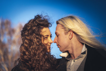 Romantic young couple on blue sky background. Feelings, love and date concept