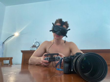 Man in googles control camera by joystick. Concept of virtual reality and technologyの写真素材